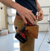 Animation of a worker dropping a drill from a cordless drill holster